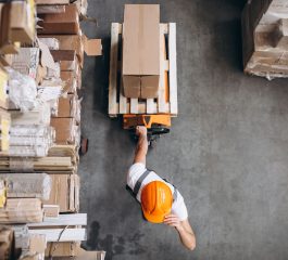 Young man working at a warehouse with boxes